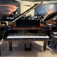 Yamaha grand piano in polished ebony finish at Classic Pianos, Seattle showroom; premium acoustic and silent models.
