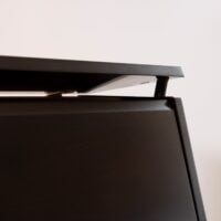 Piano lid hinge detail showcasing the sleek, modern design of Classic Pianos Seattle's high-quality instruments.
