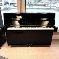Yamaha U1 upright piano, polished black finish, offering exceptional sound quality and performance for aspiring and professional pianists.