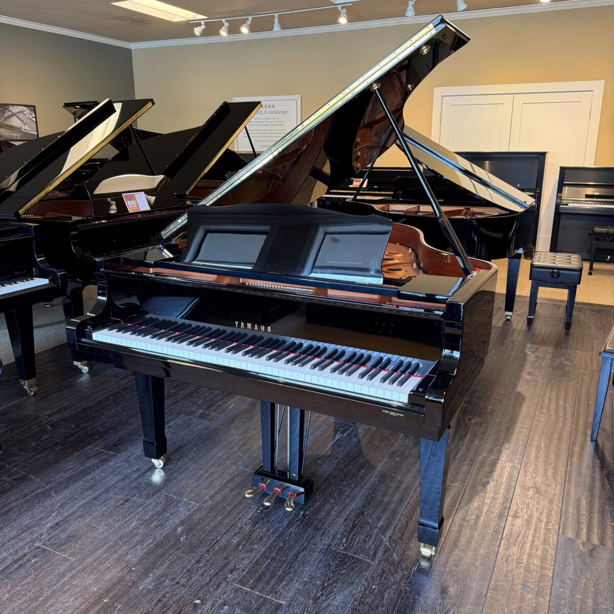 Yamaha grand piano with polished ebony finish, featuring a responsive keyboard and elegant design for superior performance.