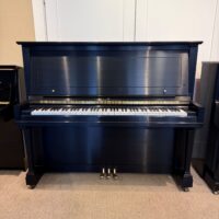 Classic upright piano with a rich ebony finish, polished keys, and detailed craftsmanship. Ideal for any music space.
