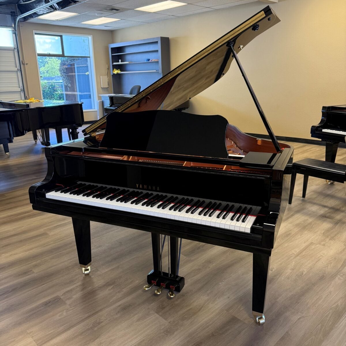 Yamaha grand piano showcasing polished ebony finish and precision-engineered keys, perfect for any classical music setting.