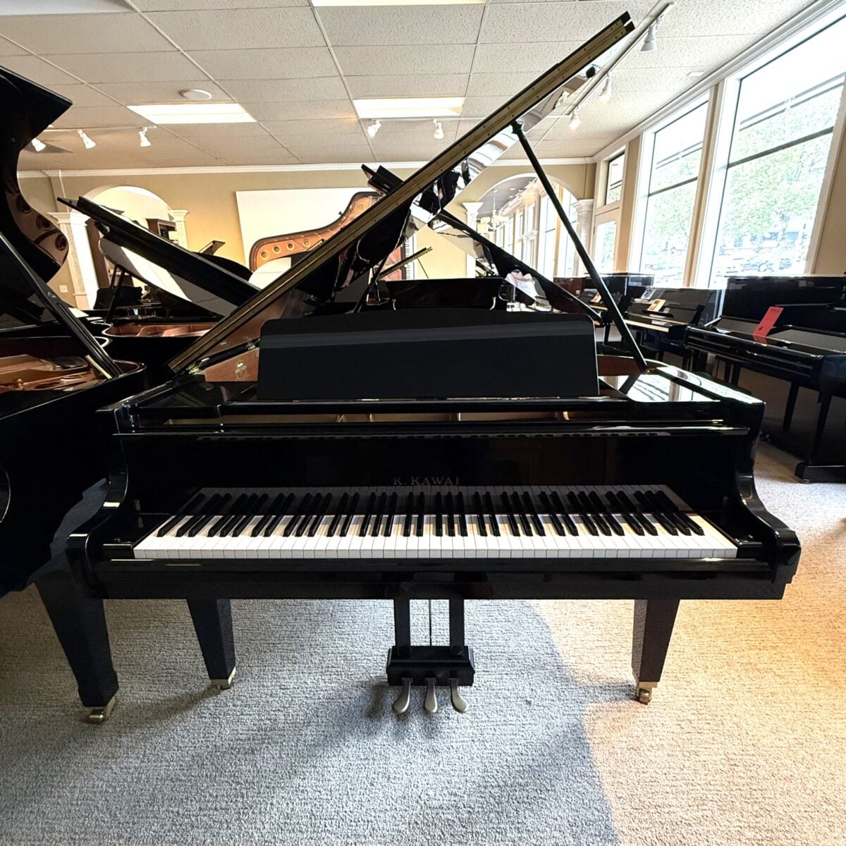 High-gloss Kawai grand piano showcasing a polished finish, suitable for professional performance and practice.