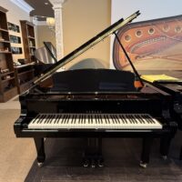 Yamaha grand piano in polished ebony finish, showcasing premium craftsmanship and exceptional sound quality for discerning musicians.
