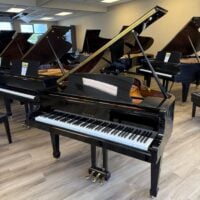 Elegant Fisher & Sons grand piano, polished black finish, showcasing a sophisticated design and premium craftsmanship.