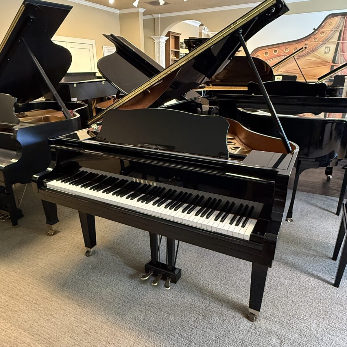 Yamaha grand piano featuring polished ebony finish and classic design, perfect for any music enthusiast.