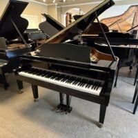 Yamaha grand piano featuring polished ebony finish and classic design, perfect for any music enthusiast.