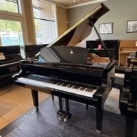 Yamaha grand piano showcased with polished ebony finish, featuring a responsive touch and exquisite sound quality.