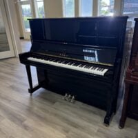 Alt text: Black Kawai upright piano featuring polished finish, classic keys, and three pedals, perfect for any music enthusiast.