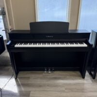 Yamaha digital piano with black finish, weighted keys, three pedals, perfect for home practice and performance.