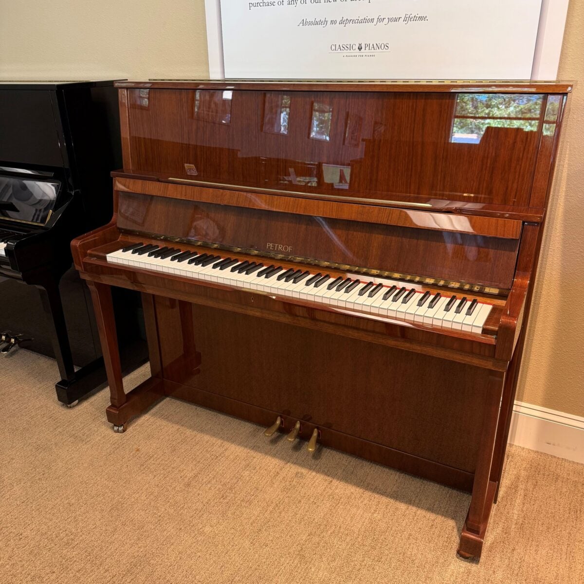 Alt text: Petrof upright piano featuring a polished mahogany finish and high-quality keys, available at Classic Pianos Seattle.
