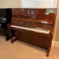 Alt text: Petrof upright piano featuring a polished mahogany finish and high-quality keys, available at Classic Pianos Seattle.