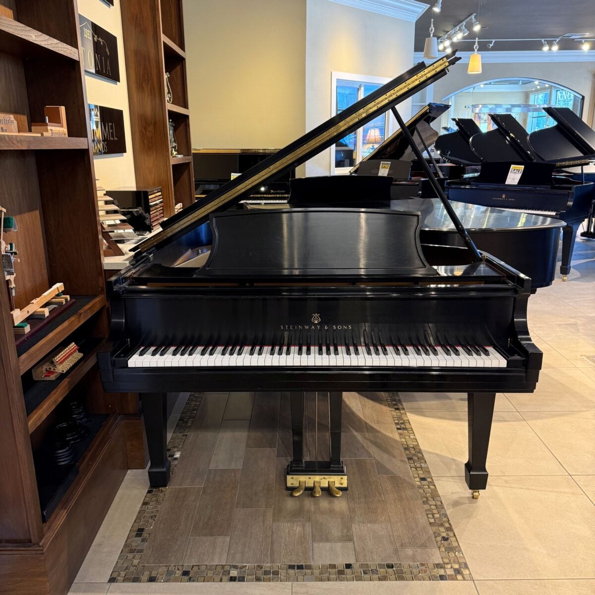 Steinway & Sons grand piano, showcasing polished ebony finish and exquisite craftsmanship in a premier piano showroom.
