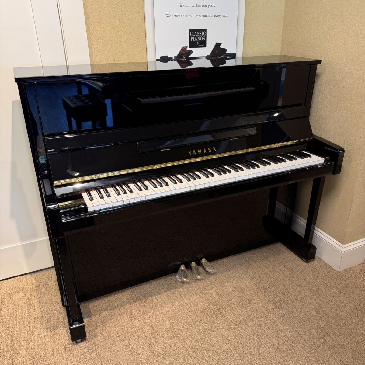 Yamaha U1 upright piano in polished ebony finish, featuring responsive action and rich tone—perfect for any musician.