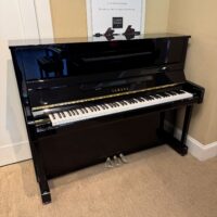 Yamaha U1 upright piano in polished ebony finish, featuring responsive action and rich tone—perfect for any musician.