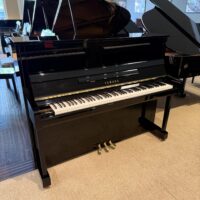 Yamaha U1 upright piano in polished black, featuring an authentic touch and rich tone, perfect for any musician's needs.